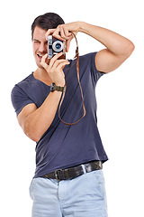 Image showing Photographer, picture and vintage camera with casual man in studio isolated on white background for hobby. Art, creative or media and young photography person with focus lens for photo shoot