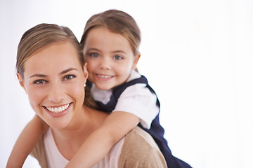 Image showing Mother, kid and piggyback in portrait in studio with games, love and bonding with smile while playing on white background. Playful woman, young girl and happy with fun time together for childhood