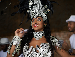 Image showing Dancer, happy and samba performance at night for celebration in Rio de janeiro for carnival season. Female person, costume and feathers for culture and show, creativity and confidence at festival