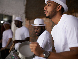 Image showing Man, percussion and night with band playing music for performance, concert or musical event. Male person or group of musicians playing instruments in late evening for sound or fun local entertainment
