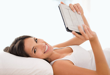 Image showing Woman, tablet and reading in bed, portrait or story with ebook, knowledge or subscription in house. Girl, person and smile with digital touchscreen for streaming app to relax at apartment in morning