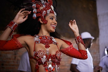 Image showing Happy woman, samba dancer and performance with costume for tradition at carnival or festival. Face of female person or exotic performer with band for culture or dancing at party or concert in Rio