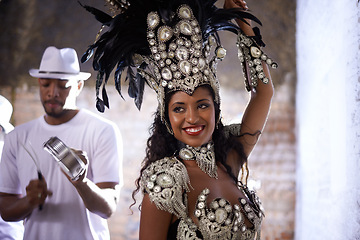 Image showing Woman, band and samba performance at night for celebration in Rio de janeiro for carnival season. Female person, costume and feathers for culture and life, creativity and confidence at festival