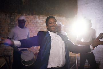 Image showing Dancing, happy man and musician with band at stage for music and celebration event. Performance, concert and smile of African person with group at party with energy, artist and drums with lens flare