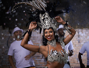 Image showing Night, woman and dancer with band at carnival in rio de janeiro for brazilian festival with feather costume or smile. Person, face and happy with samba, fashion and music for culture or outdoor event