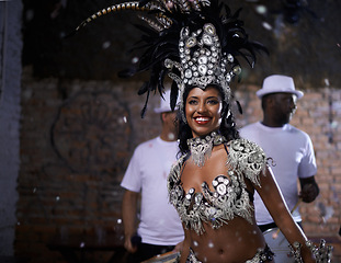 Image showing Samba, woman and dancer with band at carnival in rio de janeiro for brazilian festival with feather costume or smile. Person, face or night with dancing, fashion or music for culture or outdoor event