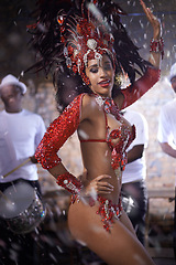 Image showing Carnival, woman with dance in street and confetti for performance in Brazil, costume and feather head gear outdoor. Music, samba and event with energy, culture for festival entertainment and talent