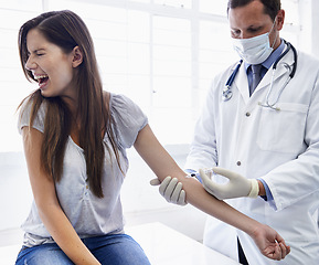 Image showing Doctor, woman and arm injection or scared scream in hospital or anxiety feaR or medicine treatment, disease or diagnosis. Male person, face mask and patient with needle panic, terror or trypanophobia