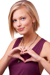 Image showing Happy woman, portrait and face with heart hands for love, support or care on a white studio background. Young female person, blonde or model with smile, like emoji or shape sign for romantic gesture