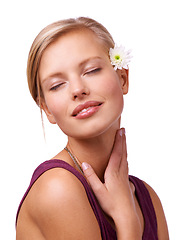 Image showing Flower, beauty and face of woman on a white background for skincare, wellness and spa aesthetic. Eye closed, attractive and isolated person with floral, bloom or plant for natural cosmetics in studio