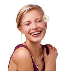 Image showing Flower, laugh and face of woman on a white background for skincare, wellness and spa aesthetic. Eyes closed, attractive and isolated person with floral, bloom or plant for natural cosmetics in studio