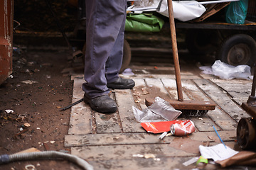 Image showing Legs, broom and sweeping dirt on floor, hygiene and cleaning for sanitation in dirty outdoors. Feet, street cleaner and equipment for mess in town, pollution and person for protection of bacteria