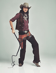 Image showing Woman, cowgirl and portrait in studio for outfit costume with confidence on white background, weapon or outlaw. Female person, whip and hat with mockup space in Texas for dress up, old west or rodeo