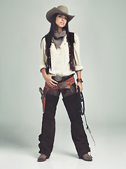 Image showing Woman, cowgirl and outfit in studio, portrait and costume for western casting with rope or whip. Female person, cowboy hat and clothes from Texas, white background and dress up for audition or ad