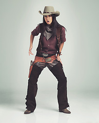 Image showing Woman, cowgirl and portrait in studio with weapon or western costume on white background, revolver or outlaw. Female person, wild and hat with mockup space in Texas for dress up, outfit or accessory