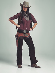 Image showing Woman, fashion and cowboy clothes with portrait in studio, western character and costume on white background. Wild west style, outlaw cosplay and vintage apparel with confidence and aesthetic