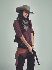 Image showing Woman, fashion and cowboy clothes with gun in studio, western character and costume isolated on white background. Wild west style, pistol for outlaw cosplay and vintage apparel in a portrait