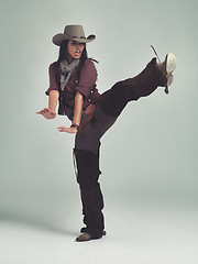 Image showing Western, woman and cowboy in studio with fashion, leg up and gesture to fight on grey background. Female person, vintage and outlaw with boots for wild west, costume and character with retro hat