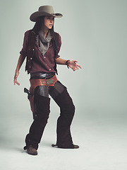 Image showing Woman, fashion and cowboy clothes with confidence in studio, western character and costume on white background. Wild west style, outlaw cosplay and vintage apparel with mockup space and aesthetic