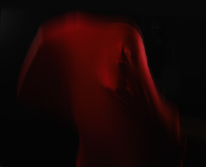 Image showing Scary, person and trapped in fabric for horror, art and drama on black background in studio. Suffocating, fear and face stuck in cloth as demon, monster or ghost with terror for creative aesthetic