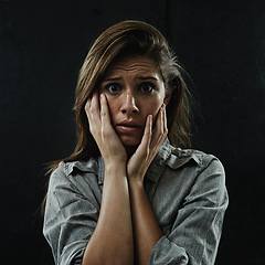 Image showing Portrait, stress and horror with phobia woman in studio on black background for reaction to fear. Face, anxiety and mental health with scared young person in dark for drama, nightmare or terror