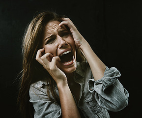 Image showing Portrait, mental health and horror with woman screaming in studio on black background for reaction to fear. Face, anxiety and stress with scared young person in dark for drama, nightmare or terror