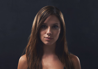 Image showing Woman, haircare and gloss for portrait in studio, cosmetics and satisfaction for keratin treatment on black background. Female person, transformation and pride for dermatology, confidence and growth