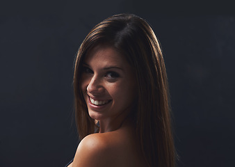 Image showing Woman, haircare and cosmetics for portrait in studio, beauty and satisfaction for keratin treatment on black background. Female person, transformation and pride for dermatology, confidence and shine