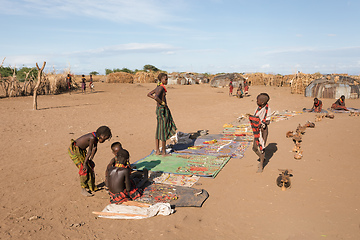 Image showing Dasanesh children offering handmade souvenirs, Omorate, Omo Valley, Ethiopia