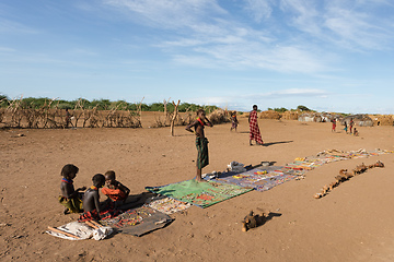 Image showing Dasanesh children offering handmade souvenirs, Omorate, Omo Valley, Ethiopia