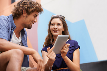 Image showing Tablet, education and couple of students on college or university campus together for learning. Technology, smile or conversation with happy young man and woman friends outdoor at school to study