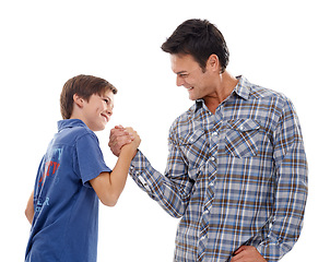Image showing Father, arm wrestle and child with strength for game of power or playful bonding on a white studio background. Dad, son or kid with friendly handshake in battle for challenge, parenting or childhood