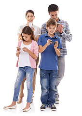 Image showing Family, phone and online in studio for communication with text message, conversation and video streaming. Father, mother and children with smartphone, technology and mobile chat on white background