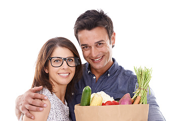 Image showing Happy couple, portrait and shopping bag with vegetables for food, natural sustainability or nutrition on a white studio background. Young man and woman with smile for healthy ingredients or groceries