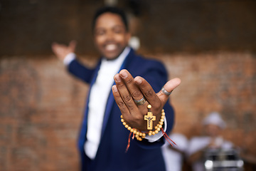 Image showing Black man, christianity and hands with cross at church for holy welcome, faith or hope of spiritual leader. Closeup of African male person, priest or preacher with rosary beads for worship of god