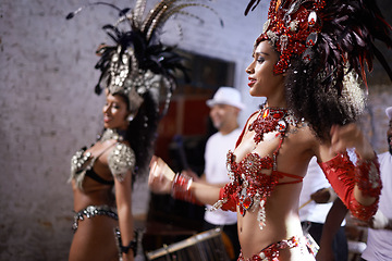 Image showing Women, dancer and samba for carnival and music festival or night performance with costume and band. Group, dancing and drums for event, celebration and culture or history in Rio de Janeiro, Brazil