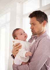 Image showing Father, care and newborn baby with love, support and console for family on paternity. Dad, single parent or man helping his child or infant with development, growth and bonding or nurture at home