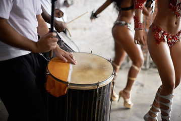 Image showing Drummer, playing and music with percussion by stage, dancers and rhythm of artist with talent in band. Brazilian people, samba or performing in group as professional musician or costume for live show