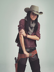 Image showing Western woman, cowgirl and strong in portrait, muscle and costume for tough with confidence. Female person, cowboy hat and clothes from Texas, white background and dress up for strength or proud