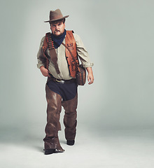 Image showing Portrait, serious and criminal cowboy in studio mockup, outlaw and wild west character with pistol. Overweight texas man, bandit face or gun belt for fighting, western or cigar by white background