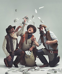 Image showing Money, thief and western with celebration of people in studio on gray background for robbery or heist. Texas, crime and smile with man gang throwing cash from bag in air for illegal theft or stealing