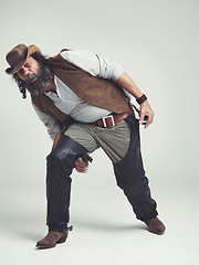 Image showing Portrait, cowboy and character with gun in studio mockup, outlaw and wild west criminal with pistol. Mature texas man, bandit face or weapon to fight or western or revolver trick by white background
