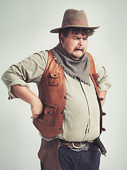 Image showing Crying, cowboy and criminal with gun in studio mockup, outlaw and wild west character with pistol. Overweight texas man, bandit and vintage clothes or western costume and loser by white background