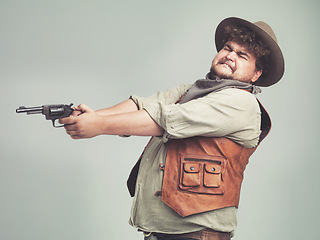 Image showing Cowboy, funny man and shooting gun in studio, weapon and pistol for western fight isolated on a white background. Plus size, criminal and person with revolver, scared or guess aim with fear in Texas