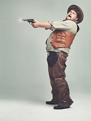 Image showing Cowboy, man and shooting gun in studio, pistol or western fight isolated on a white background mockup space. Plus size, funny criminal and person with revolver, scared or screaming with fear in Texas