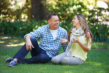 Image showing Relax, chat and couple laughing on grass for summer romance, park and fun outdoor date. Love, mature man and happy woman in garden with morning sunshine, conversation and marriage bonding in nature.