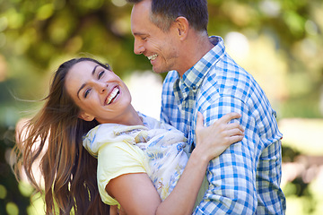 Image showing Couple, portrait and hug with love in garden together, bonding and romance for relationship with commitment. Man, woman and affection for dating with care, happy and spouse for comfort in nature