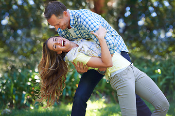Image showing Love, smile and playful couple in park for summer fun and outdoor date together in nature. Romance, mature man and happy woman in garden with morning sunshine, playing and marriage bonding in trees.