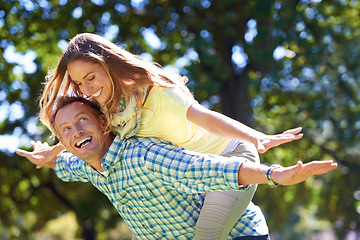 Image showing Smile, piggy back and couple in park for summer romance, trees and playful outdoor date. Love, mature man and happy woman in garden with morning sunshine, games and marriage bonding in nature.