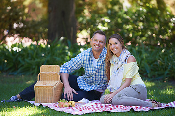 Image showing Portrait, picnic and couple with love, basket and happiness with romance and Valentines day with marriage. Date, man and woman on the ground, relationship or anniversary with celebration or honeymoon